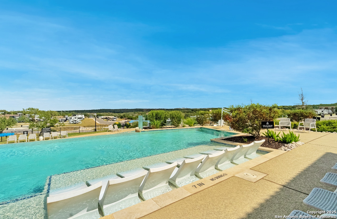 5386 Ranch Road 1376, Unit 232 Fredericksburg, TX 78624 - Photo 9 of 13 a view of a swimming pool and an ocean view