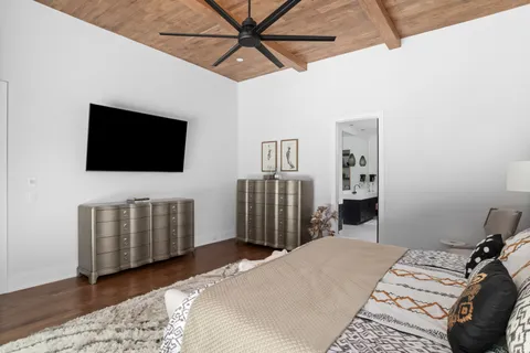 a bedroom with a bed and a flat screen tv