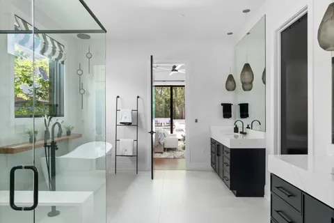 a spacious bathroom with a bathtub sink and mirror