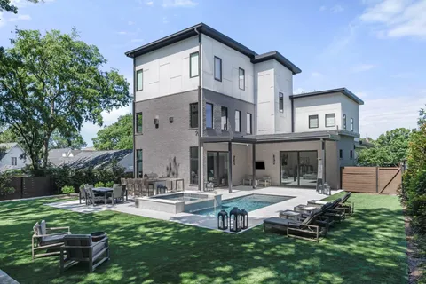 a front view of a house with patio and a garden