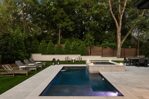 a view of a patio with swimming pool and sitting area