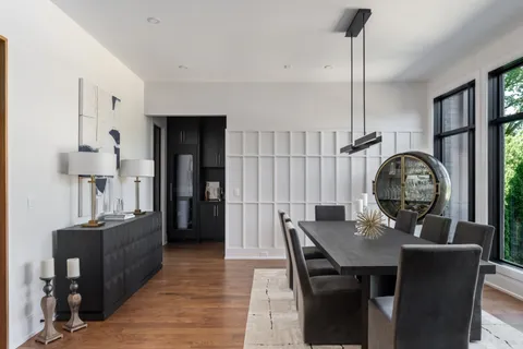 a dining room with furniture and wooden floor
