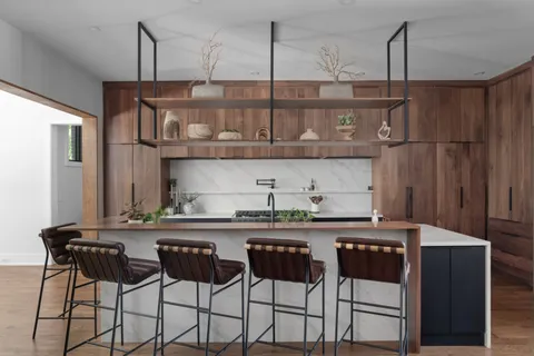 a kitchen with granite countertop a table chairs stove and cabinets