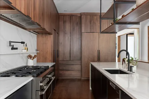 a kitchen with kitchen island stainless steel appliances a sink stove and cabinets