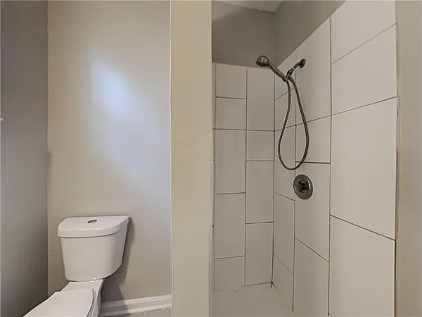 a bathroom with a toilet and shower