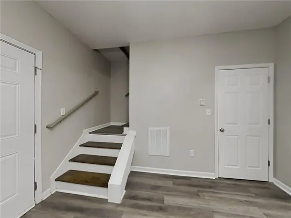 a view of entryway and hall with wooden floor
