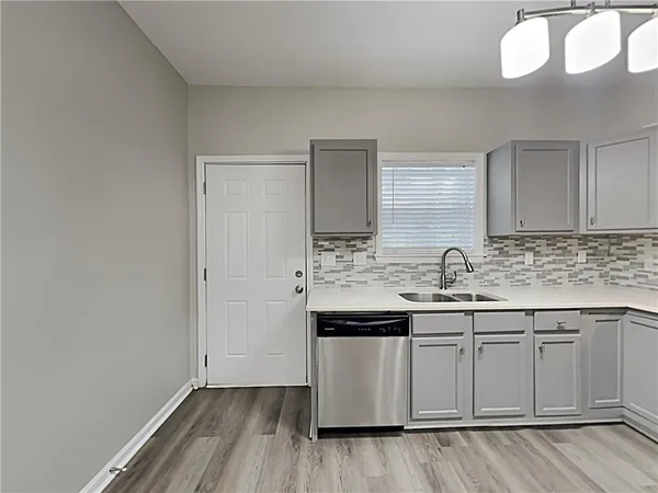a kitchen with sink cabinets and wooden floor