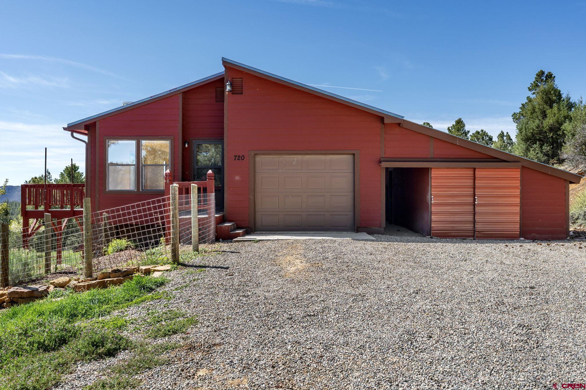 720 Sawmill Road Durango, CO 81303 - Photo 33 of 41 a front view of a house with garden