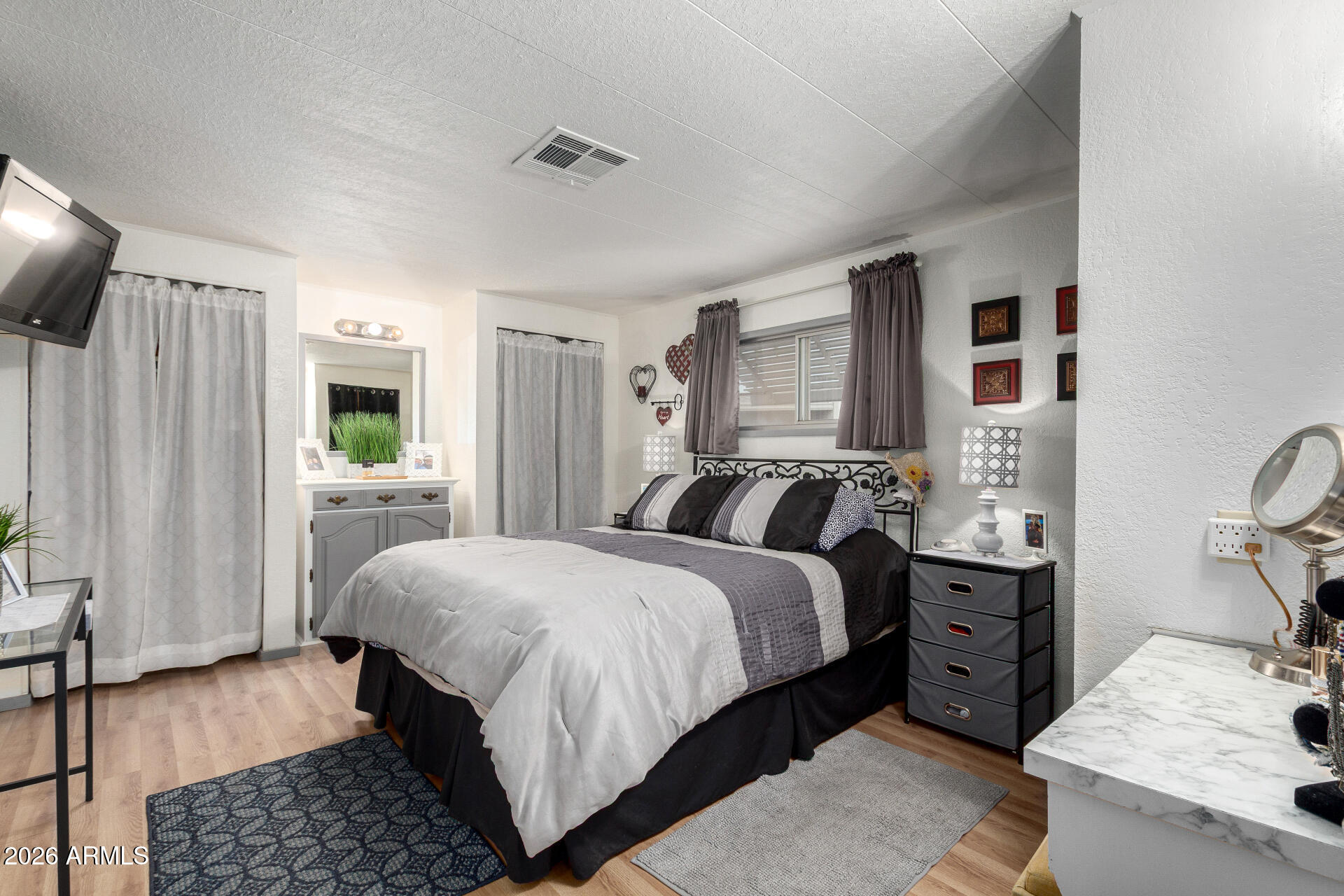 800 West Apache Trail, Unit 93 Apache Junction, AZ 85120 - Photo 23 of 28 a bedroom with a bed and wooden floor