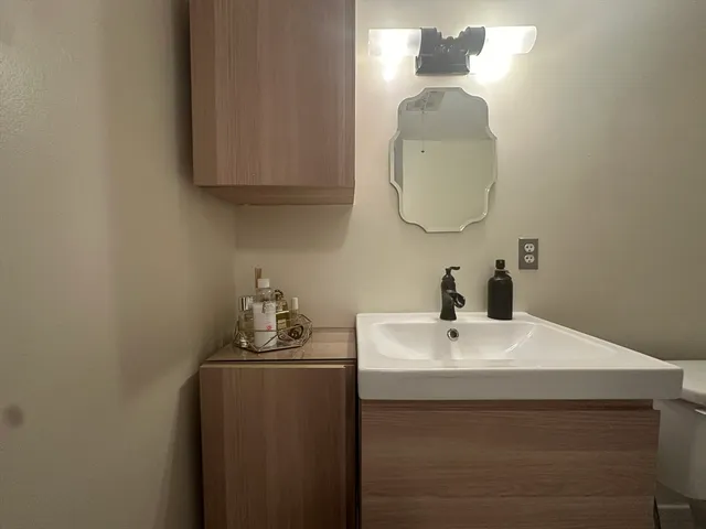 a bathroom with a sink and a mirror