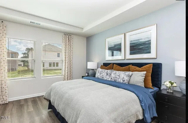a view of a yard in front of a brick house with a large window