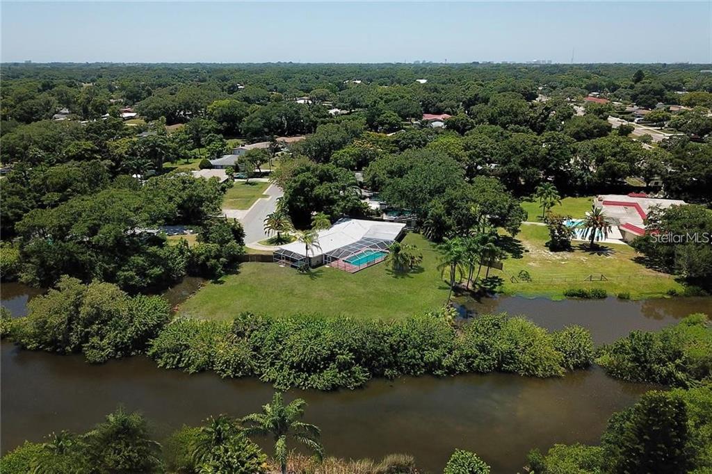 1875 Belleair Road Clearwater, FL 33764 - Photo 9 of 100 an aerial view of residential houses with outdoor space and lake view