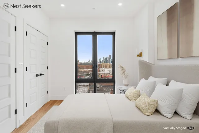 a bedroom with a bed and a large window