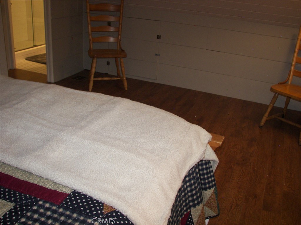 1101 Big Tree Lane Crestline, CA 92325 - Photo 20 of 30 a bedroom with a bed and a chair