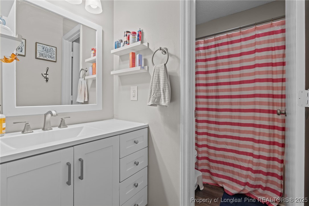 76 North Hillside Drive Spring Lake, NC 28390 - Photo 26 of 50 a bathroom with a sink and a mirror