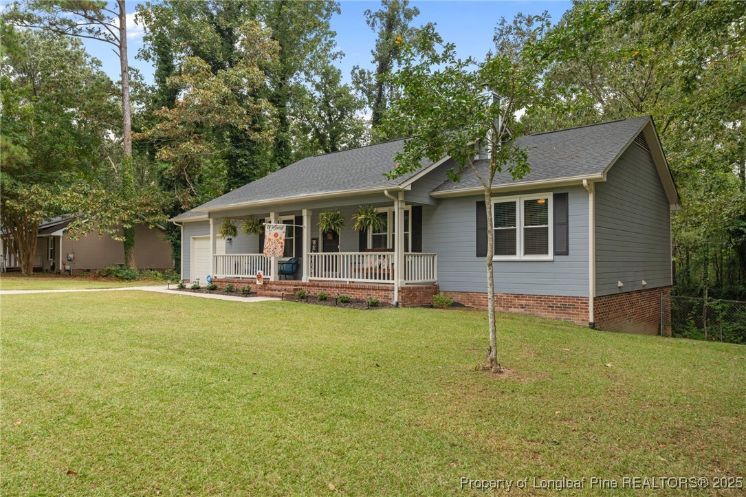 76 North Hillside Drive Spring Lake, NC 28390 - Photo 36 of 50 a view of a house with a backyard and a tree