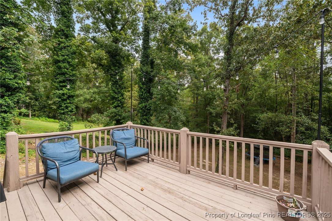 76 North Hillside Drive Spring Lake, NC 28390 - Photo 42 of 50 a view of roof deck with furniture and trees
