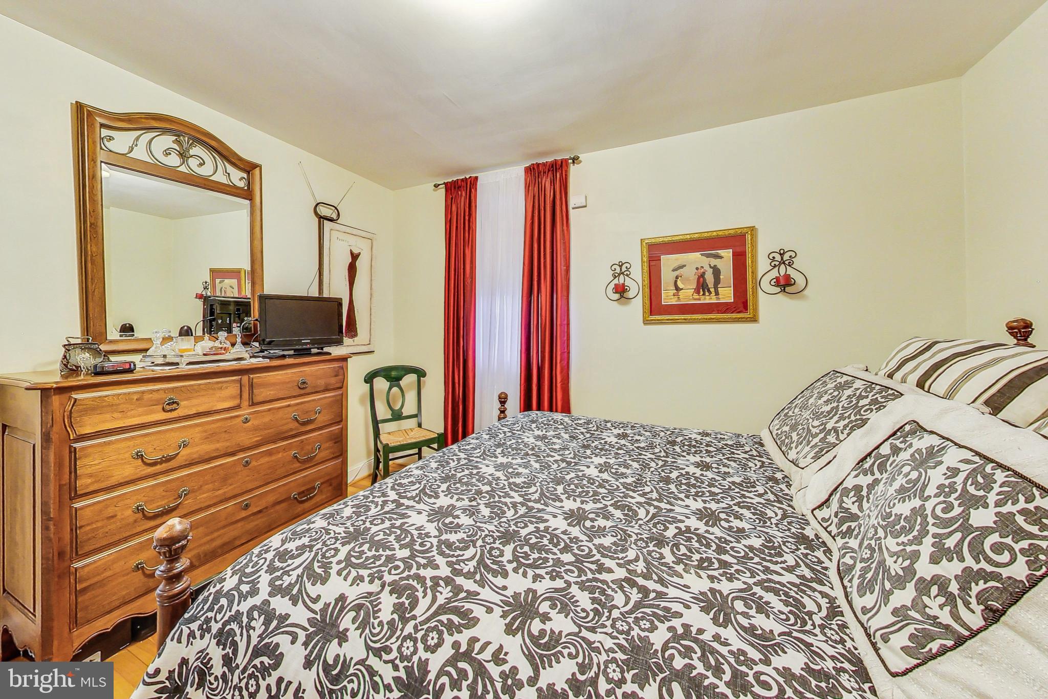 10404 Grandin Road Silver Spring, MD 20902 - Photo 15 of 38 a bedroom with a bed and a dresser in it
