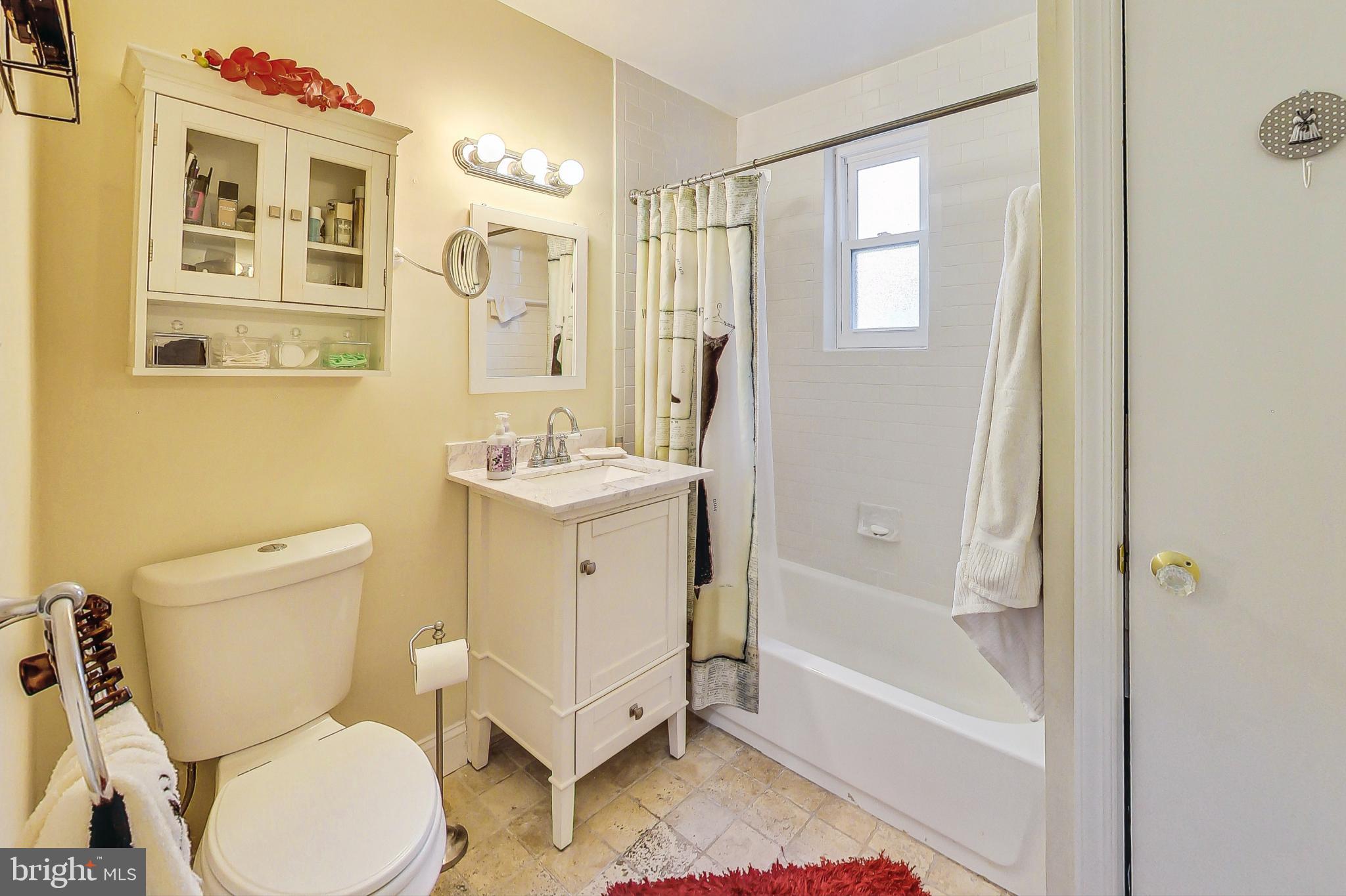 10404 Grandin Road Silver Spring, MD 20902 - Photo 19 of 38 a bathroom with a sink toilet and shower