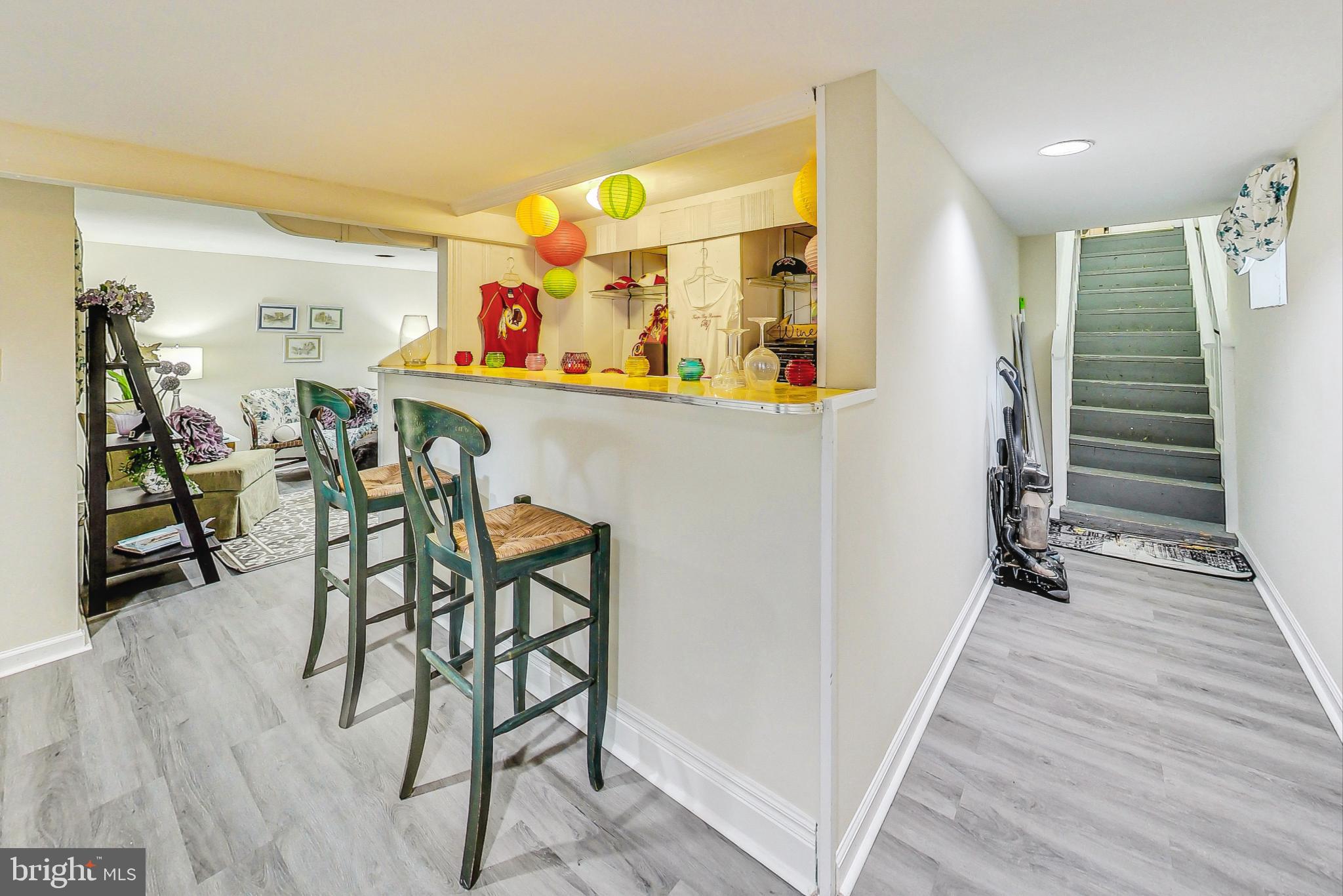 10404 Grandin Road Silver Spring, MD 20902 - Photo 24 of 38 a view of a hallway with wooden floor and furniture