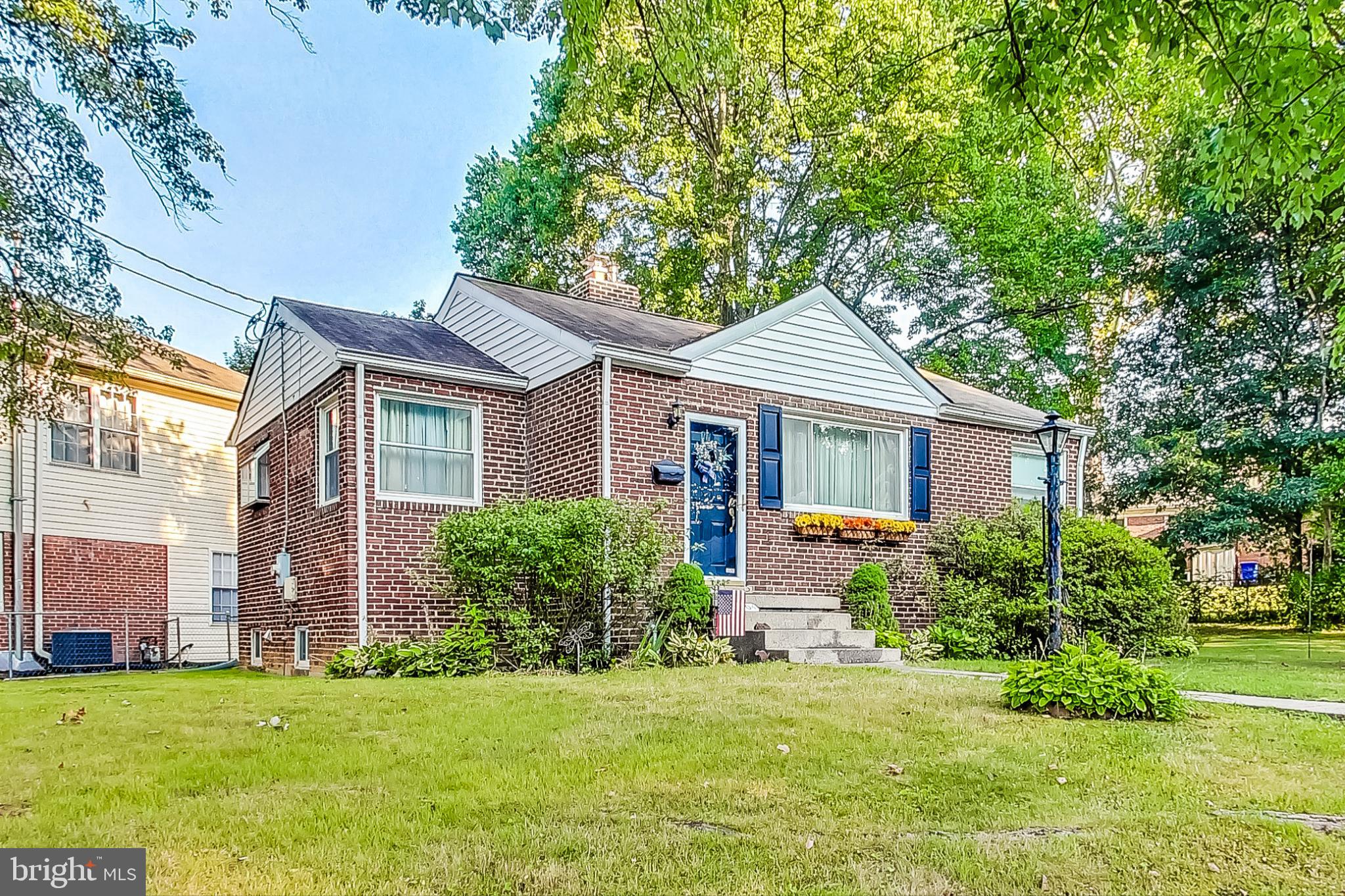10404 Grandin Road Silver Spring, MD 20902 - Photo 3 of 38 a front view of a house with a yard and trees