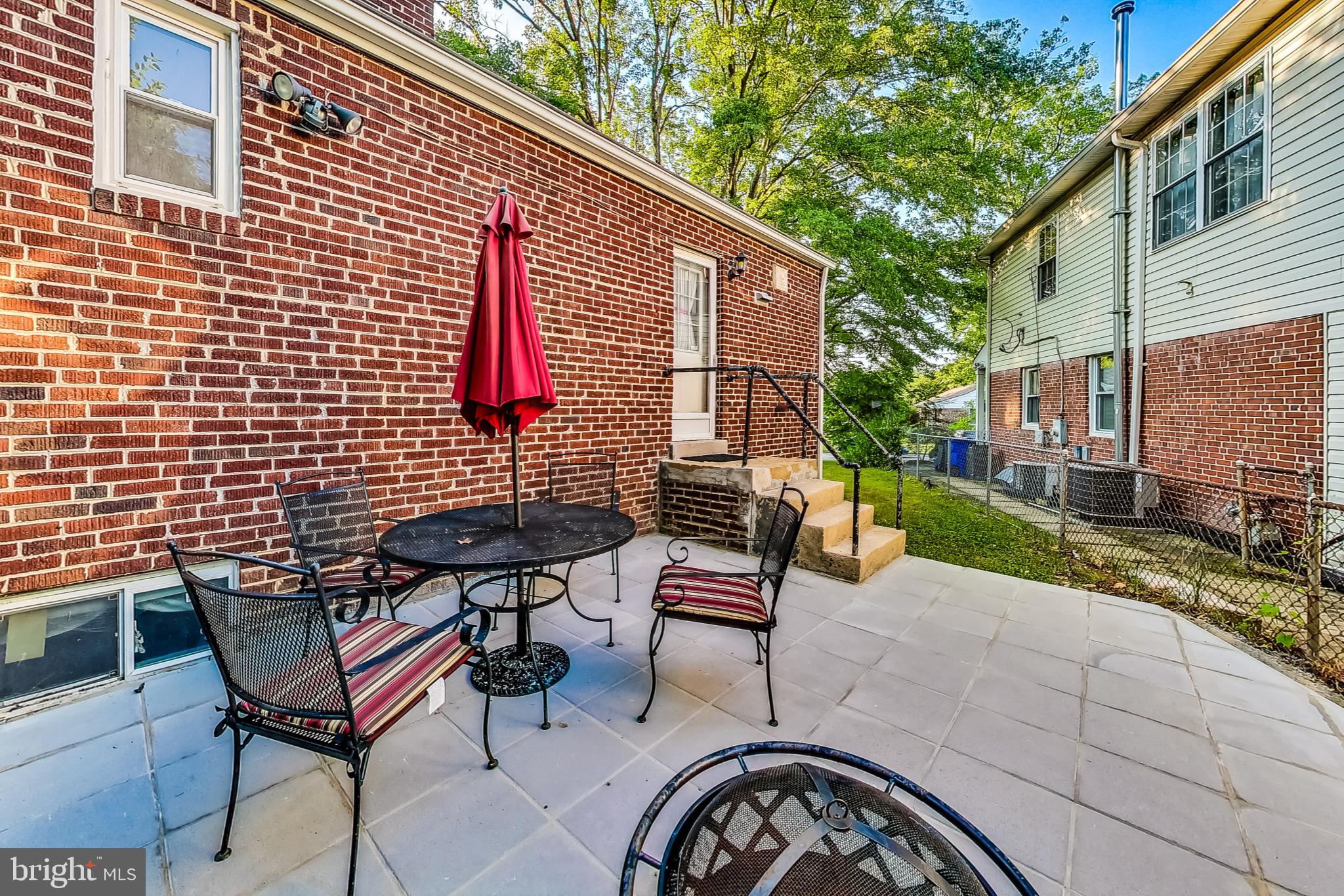 10404 Grandin Road Silver Spring, MD 20902 - Photo 31 of 38 a view of a patio with a table and chairs and a barbeque