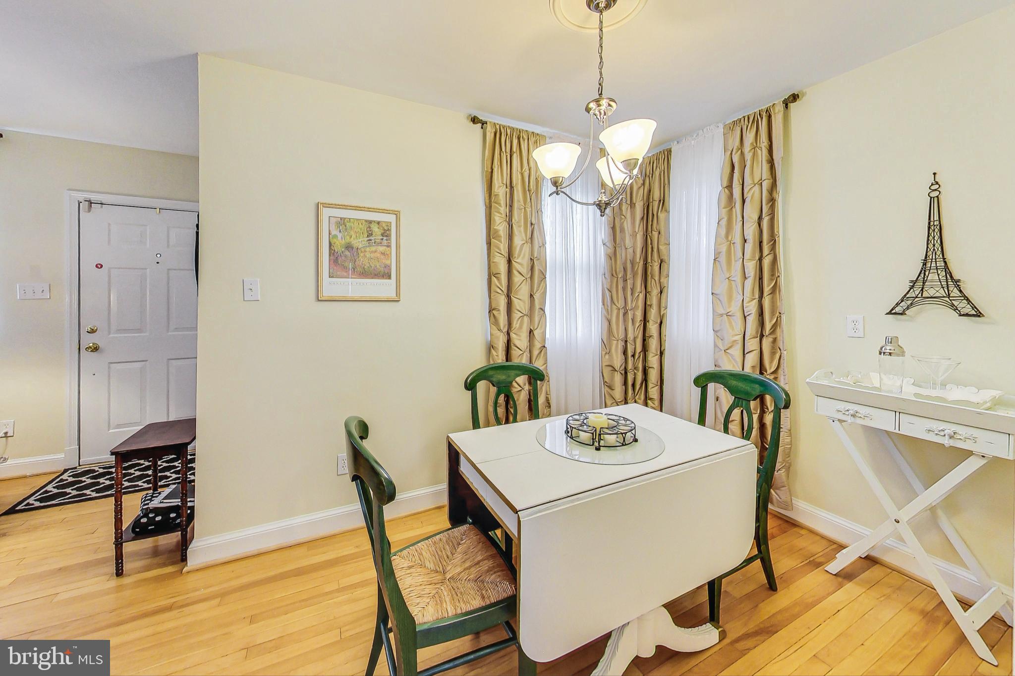 10404 Grandin Road Silver Spring, MD 20902 - Photo 8 of 38 a dining room with furniture and wooden floor