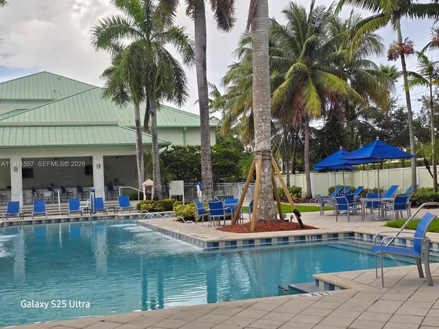 a view of a swimming pool with chairs