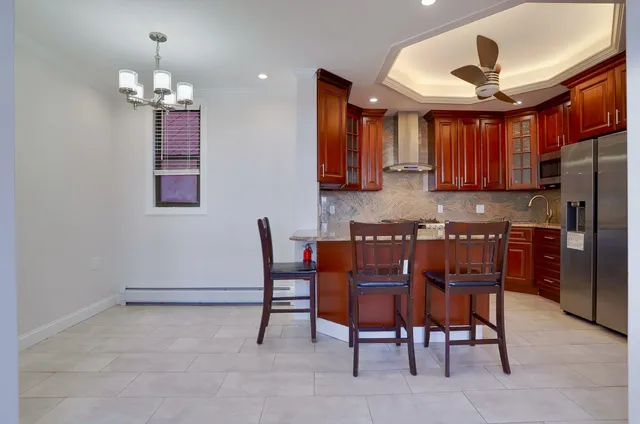 a kitchen with cabinets a sink dining table and chairs