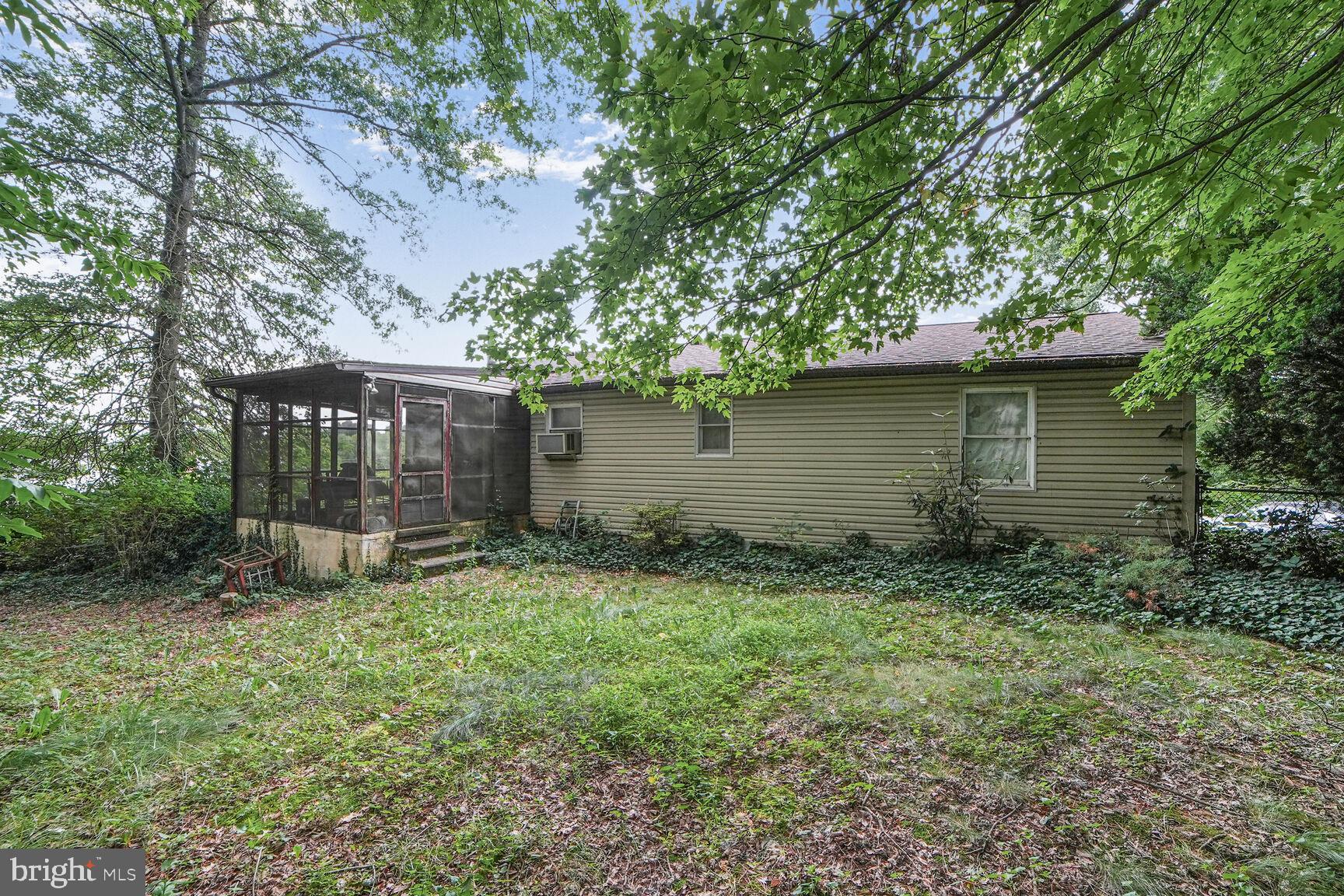 3263 Hawks Hill Road New Windsor, MD 21776 - Photo 18 of 19 a backyard of a house with large trees and barbeque oven