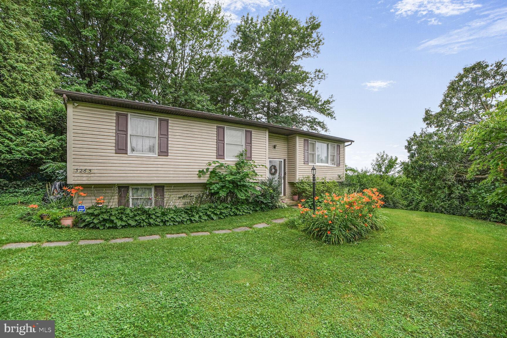 3263 Hawks Hill Road New Windsor, MD 21776 - Photo 2 of 19 a front view of house with a garden