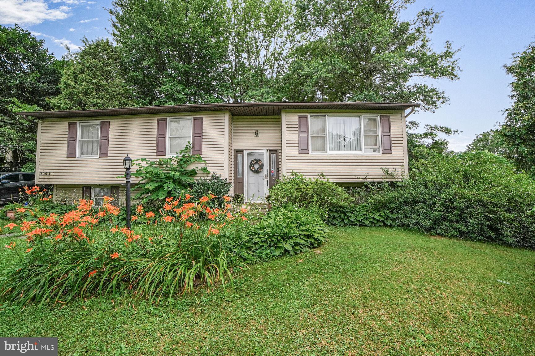 3263 Hawks Hill Road New Windsor, MD 21776 - Photo 3 of 19 a front view of a house with a garden