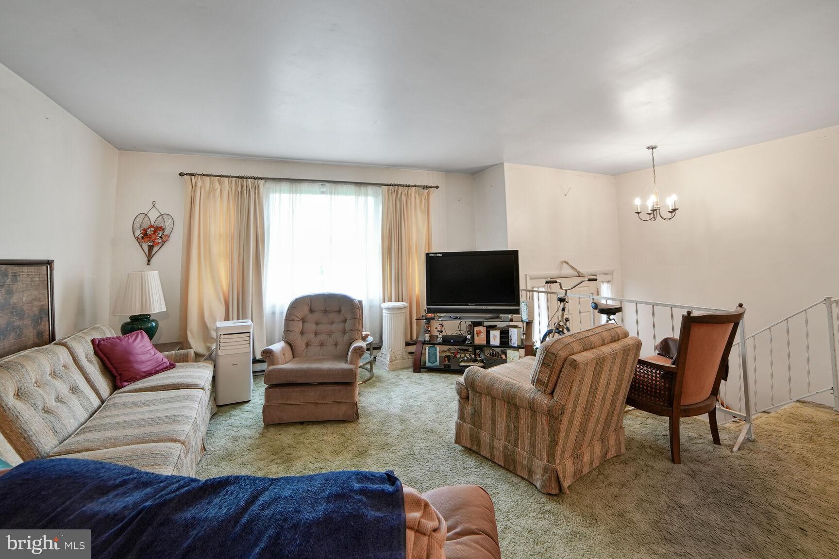 3263 Hawks Hill Road New Windsor, MD 21776 - Photo 6 of 19 a living room with furniture and a flat screen tv
