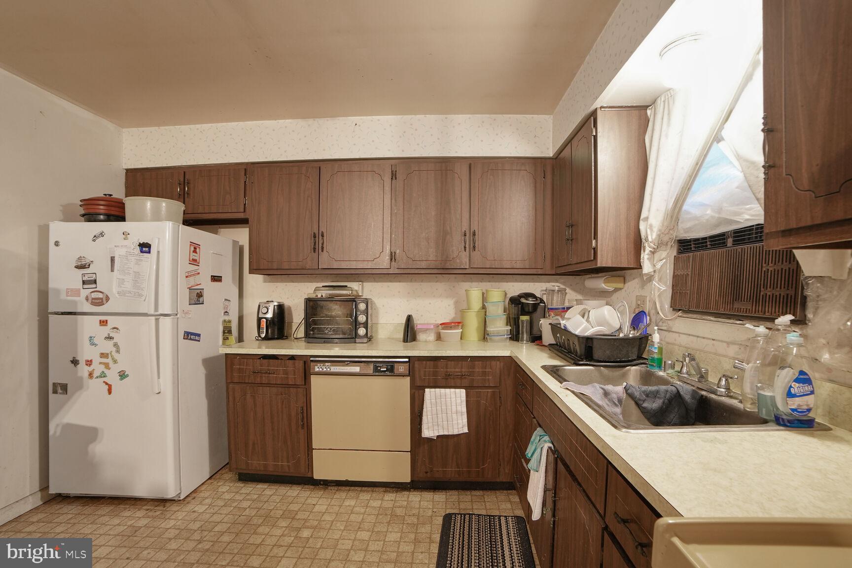 3263 Hawks Hill Road New Windsor, MD 21776 - Photo 9 of 19 a kitchen with stainless steel appliances white cabinets sink and a refrigerator