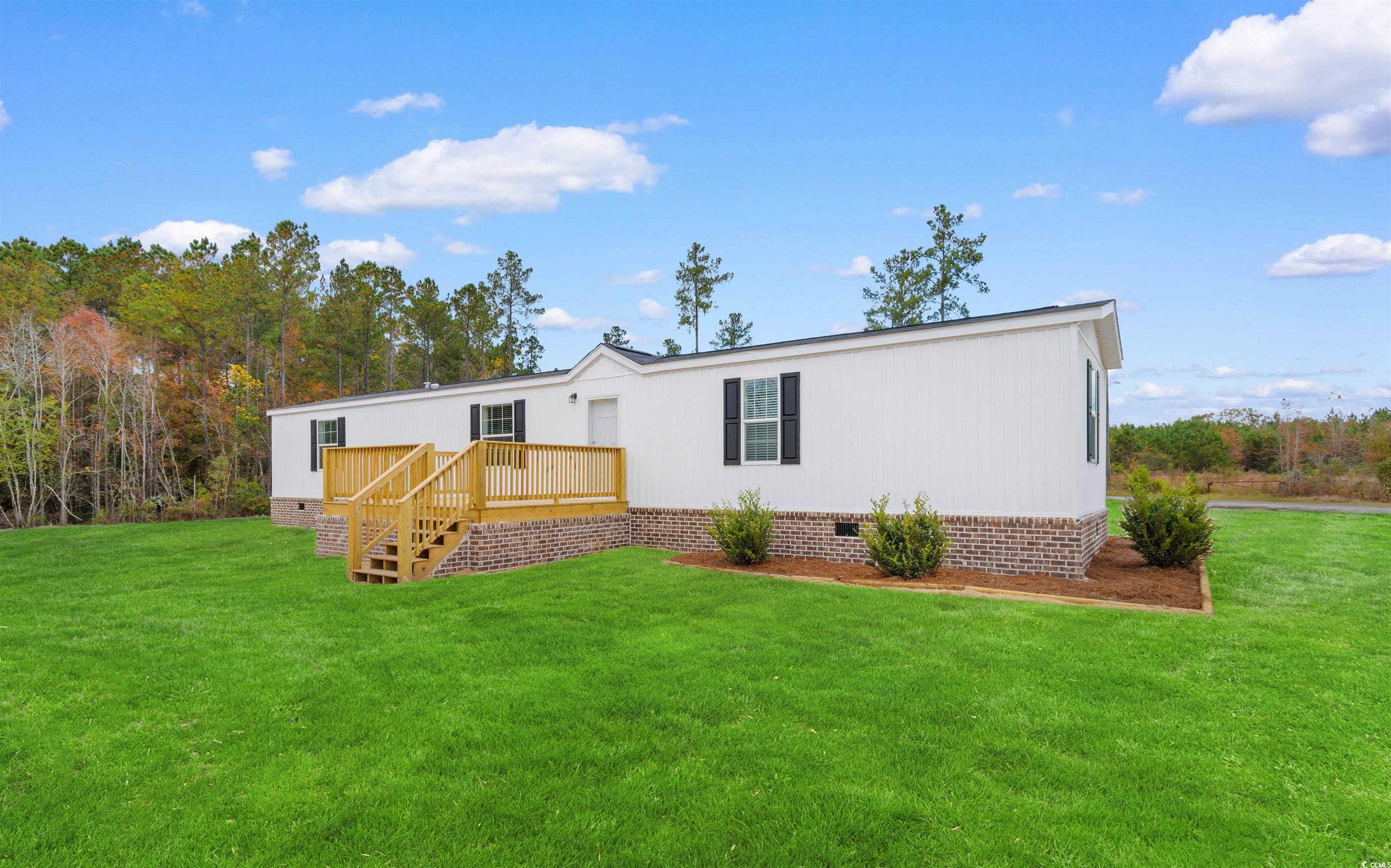 121 Feather Drive Georgetown, SC 29440 - Photo 2 of 40 Rear view of house with crawl space, a yard, a deck, and stairway