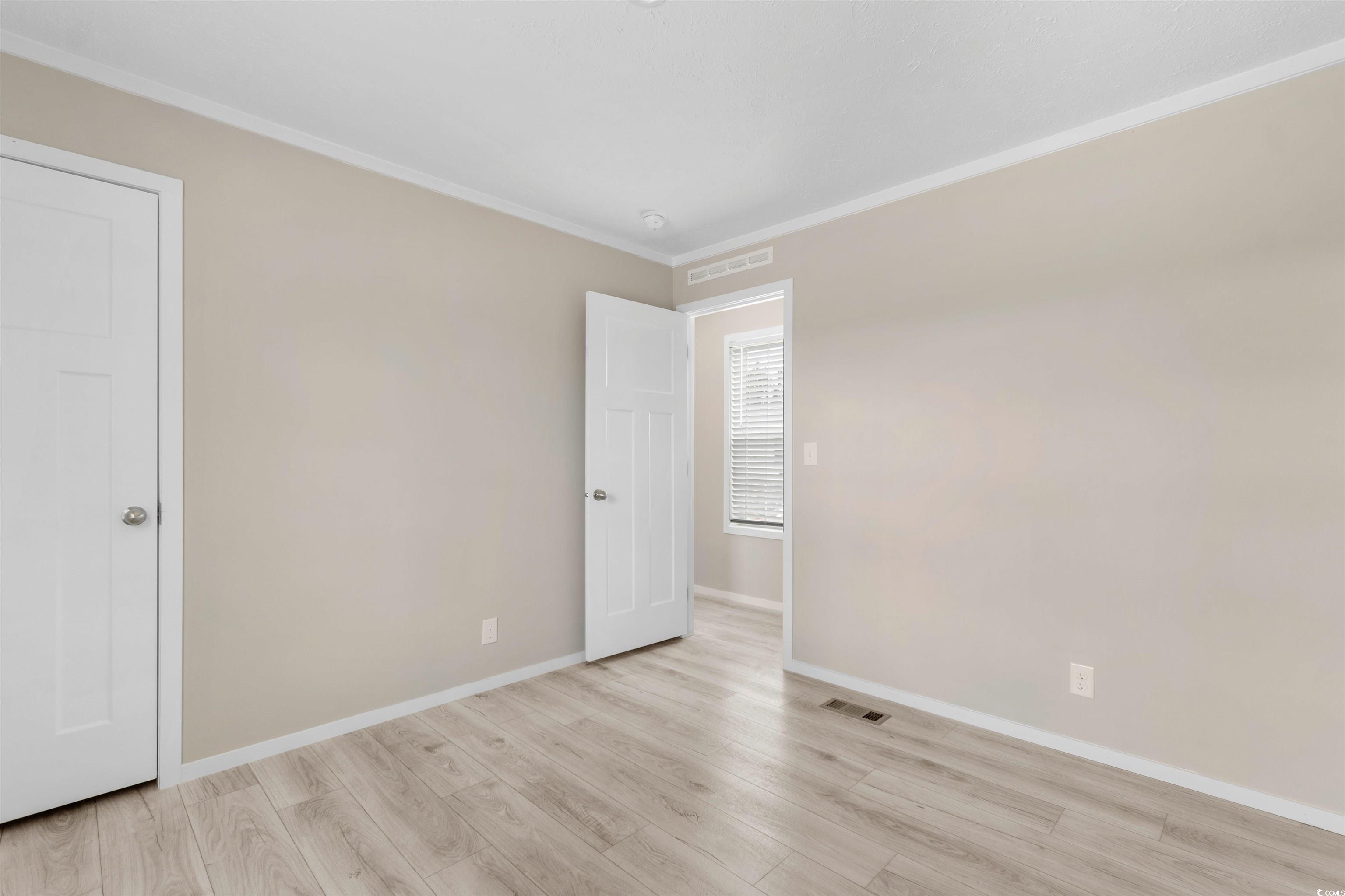 121 Feather Drive Georgetown, SC 29440 - Photo 22 of 40 Spare room featuring crown molding and light wood finished floors