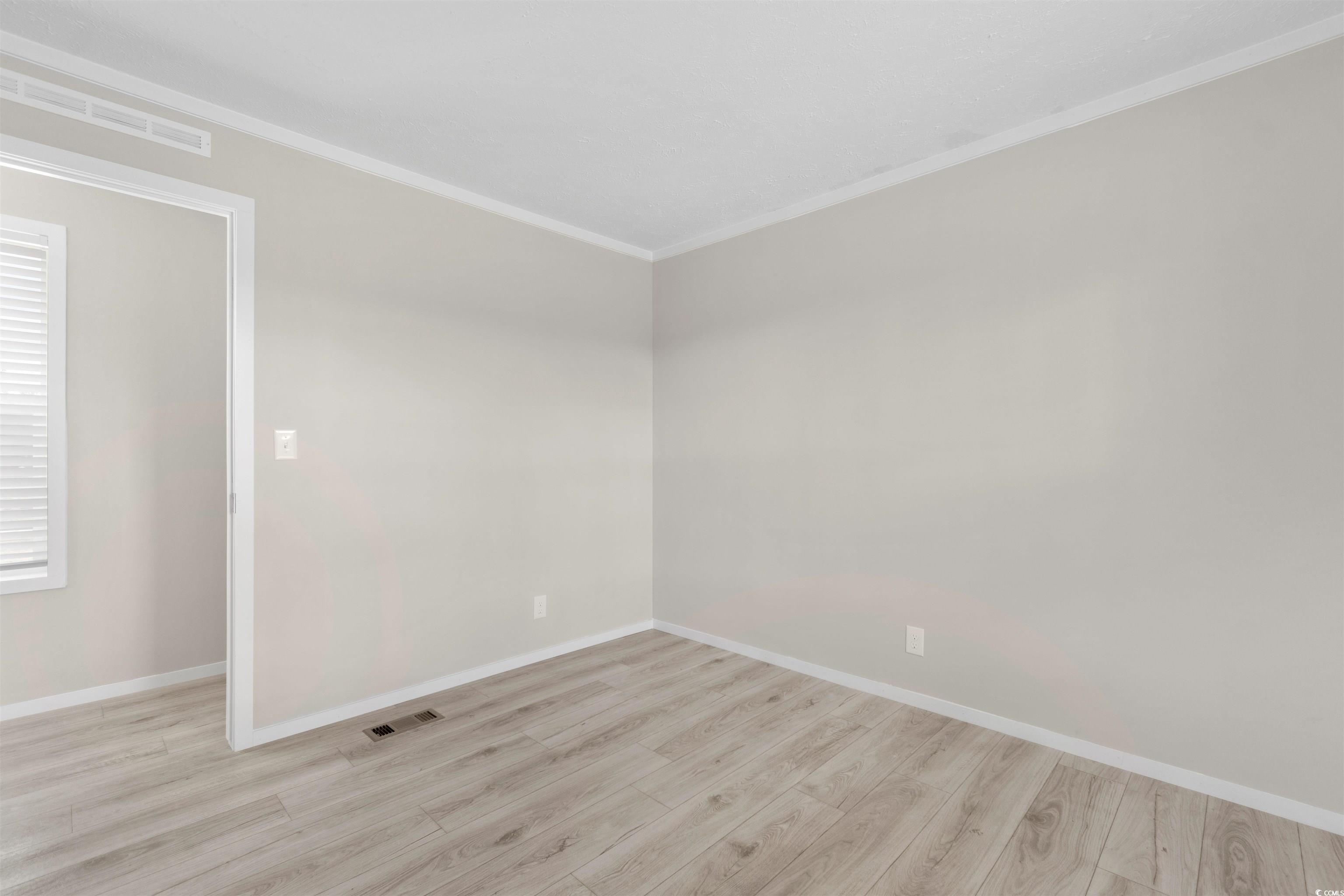 121 Feather Drive Georgetown, SC 29440 - Photo 23 of 40 Unfurnished room with ornamental molding and light wood-style floors