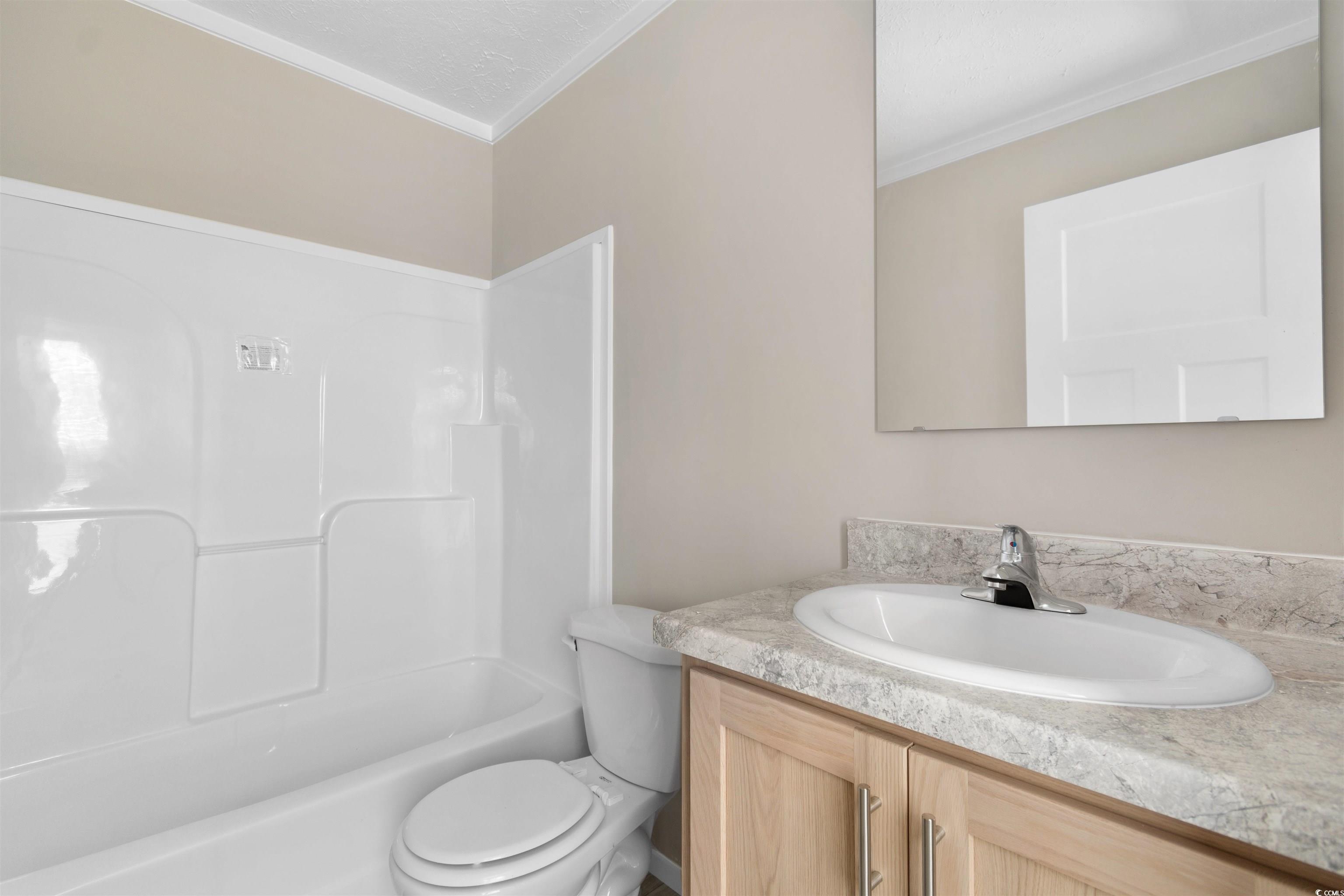 121 Feather Drive Georgetown, SC 29440 - Photo 24 of 40 Bathroom featuring vanity, shower / bath combination, and crown molding