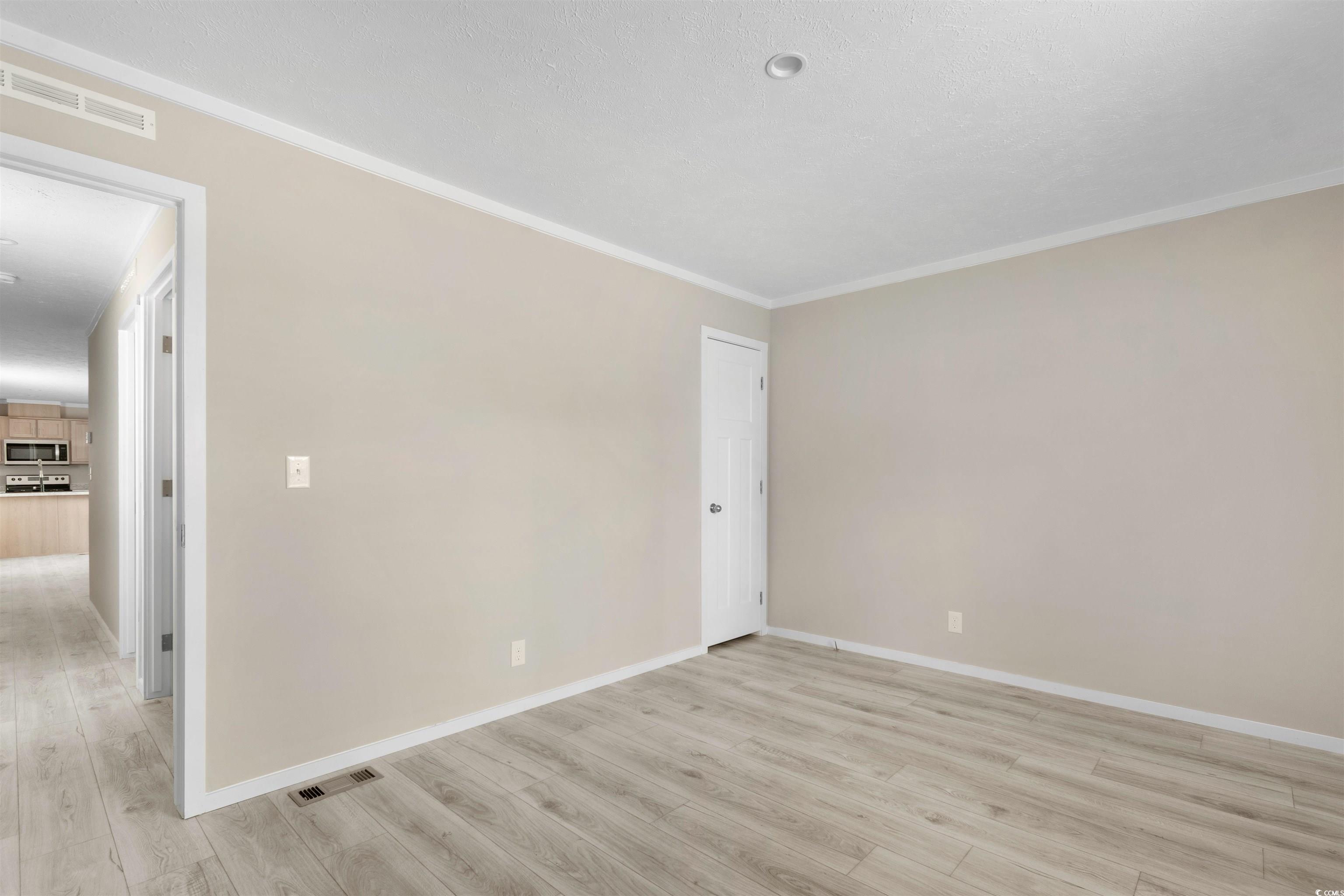 121 Feather Drive Georgetown, SC 29440 - Photo 27 of 40 Unfurnished room featuring light wood-type flooring and ornamental molding