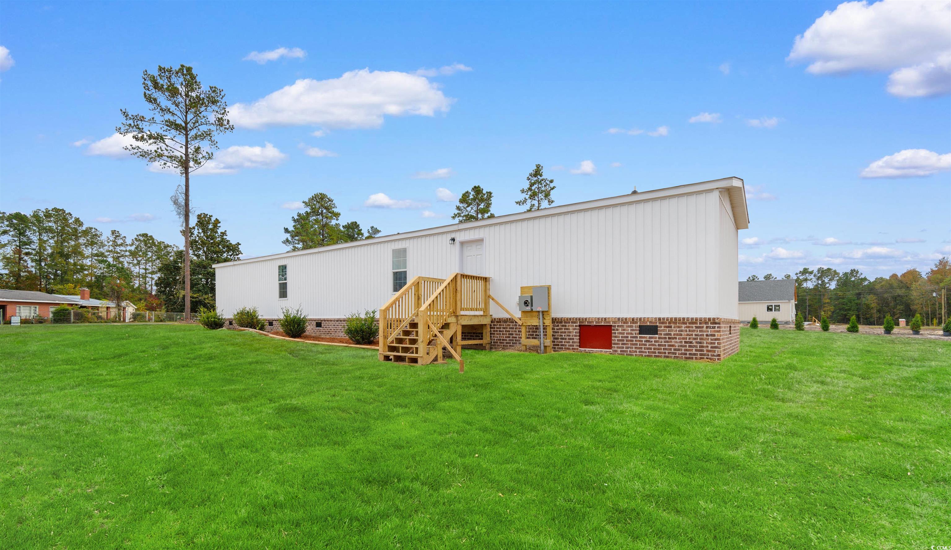 121 Feather Drive Georgetown, SC 29440 - Photo 4 of 40 Rear view of property with crawl space and a yard