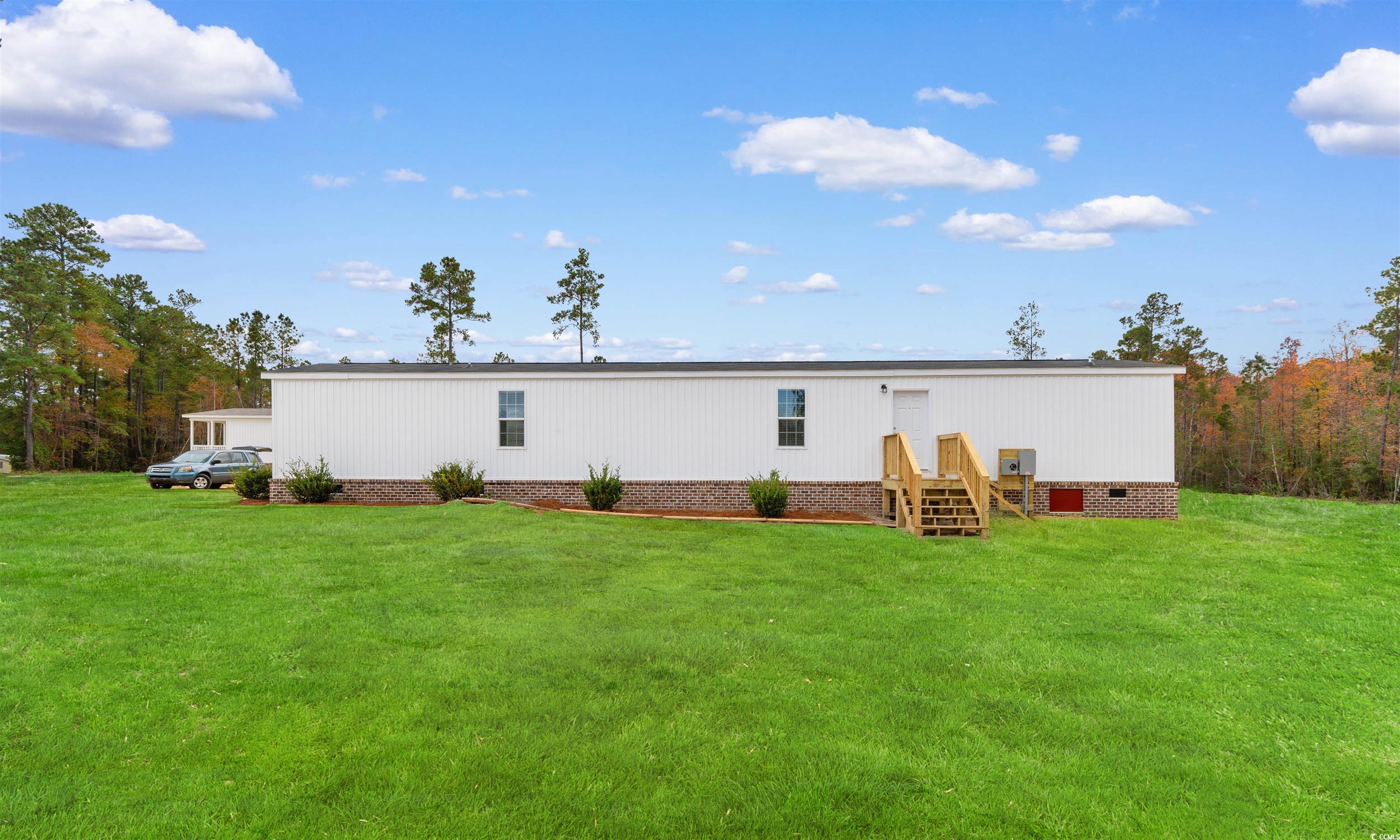 121 Feather Drive Georgetown, SC 29440 - Photo 8 of 40 Rear view of house featuring a lawn
