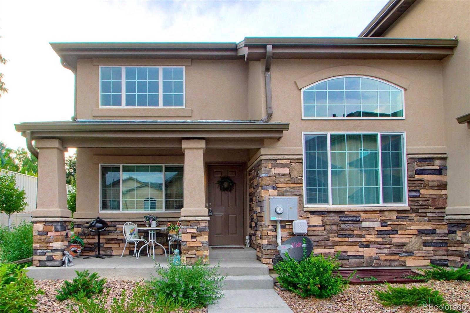1335 South Chambers Road, Unit 101 Aurora, CO 80017 - Photo 1 of 40 a front view of a house with outdoor seating