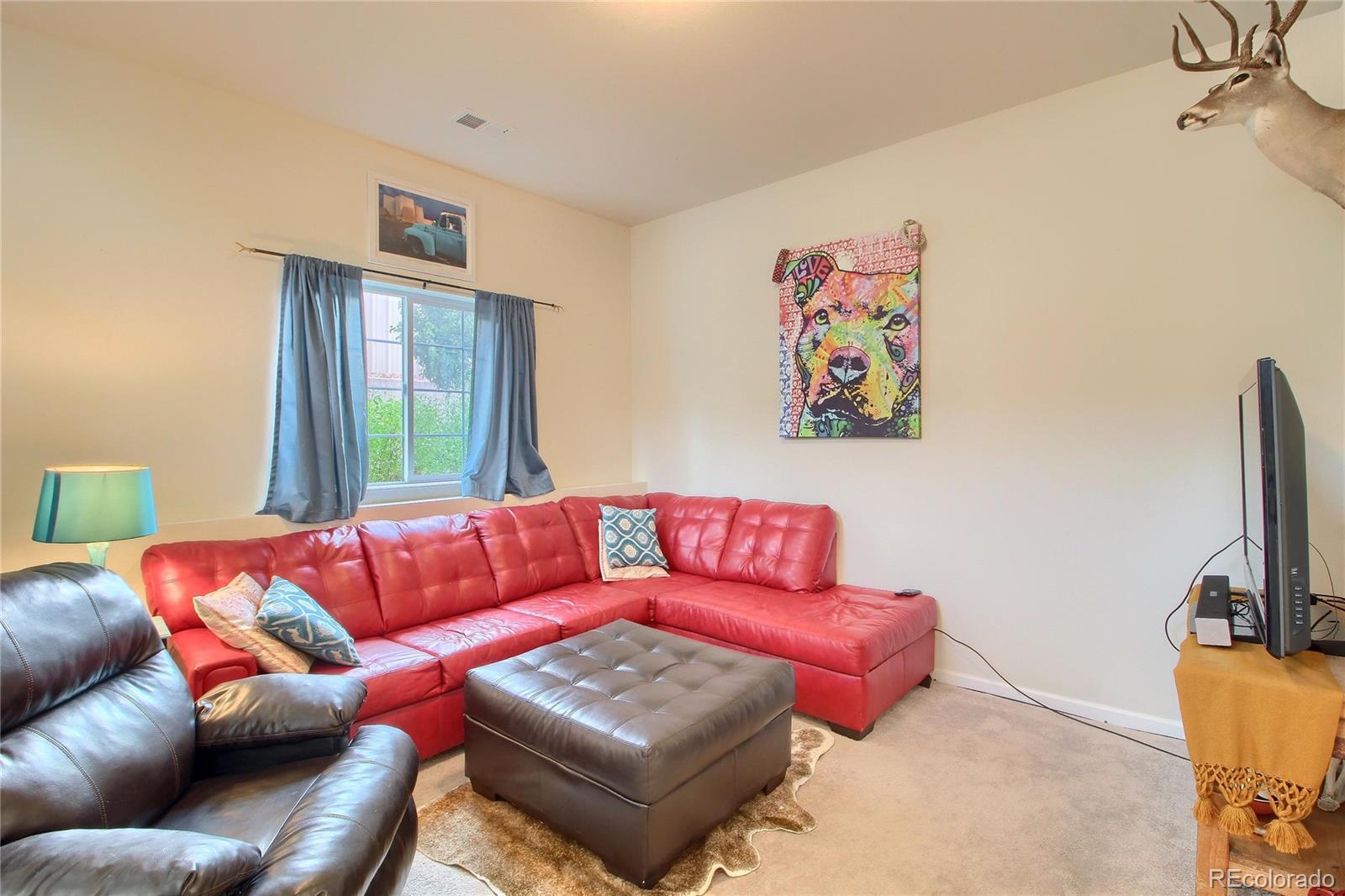 1335 South Chambers Road, Unit 101 Aurora, CO 80017 - Photo 12 of 40 a living room with furniture a couch and a flat screen tv