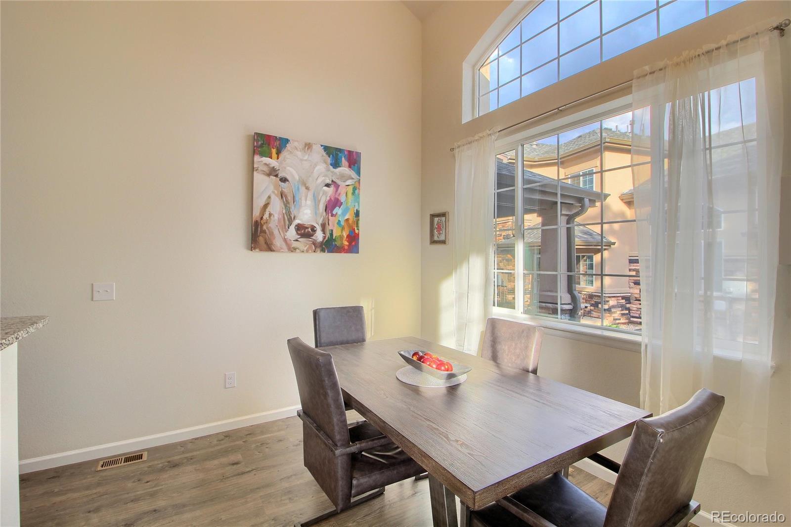 1335 South Chambers Road, Unit 101 Aurora, CO 80017 - Photo 18 of 40 a view of a dining room with furniture window and wooden floor
