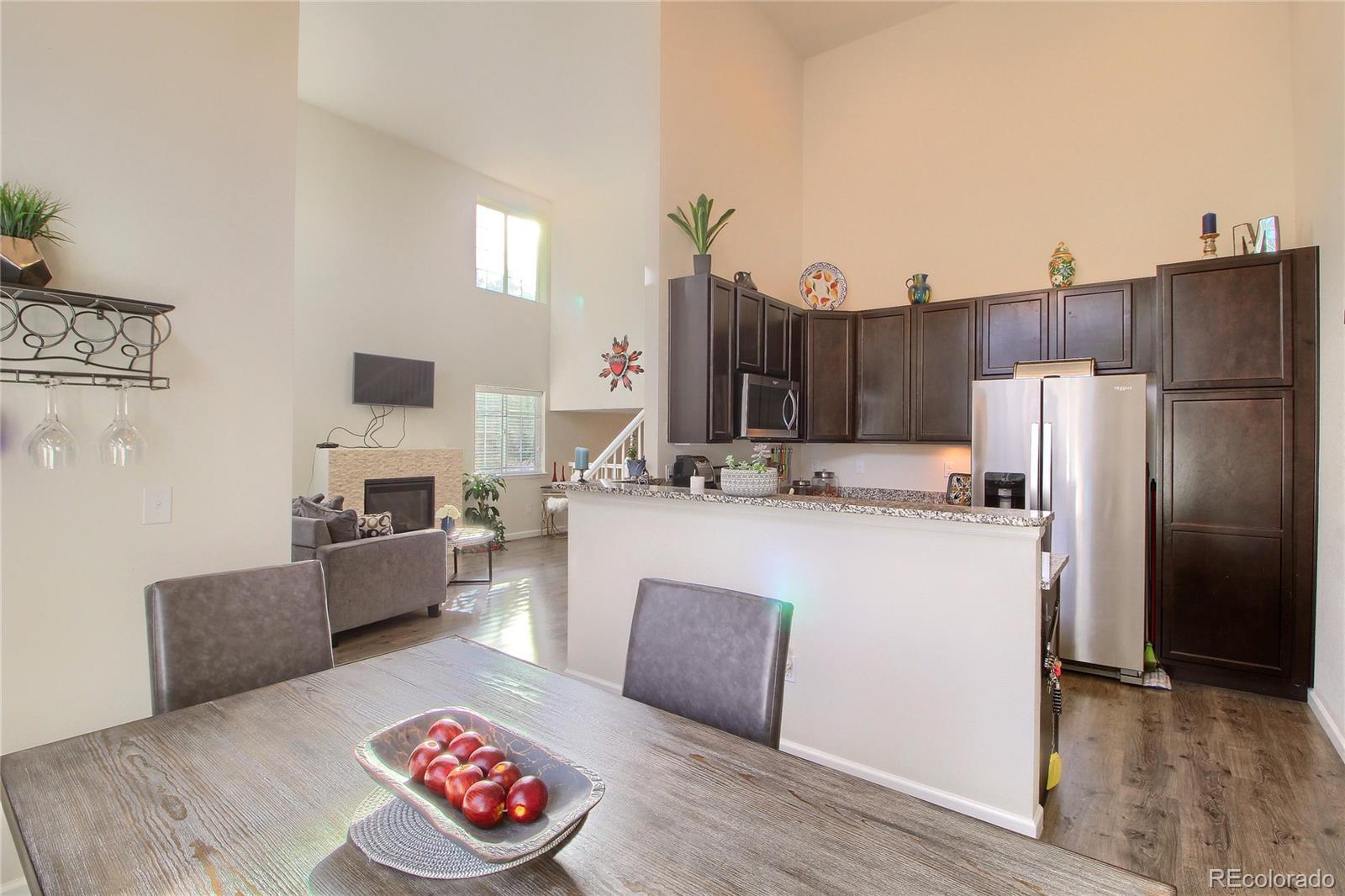1335 South Chambers Road, Unit 101 Aurora, CO 80017 - Photo 20 of 40 a living room with furniture and a fireplace