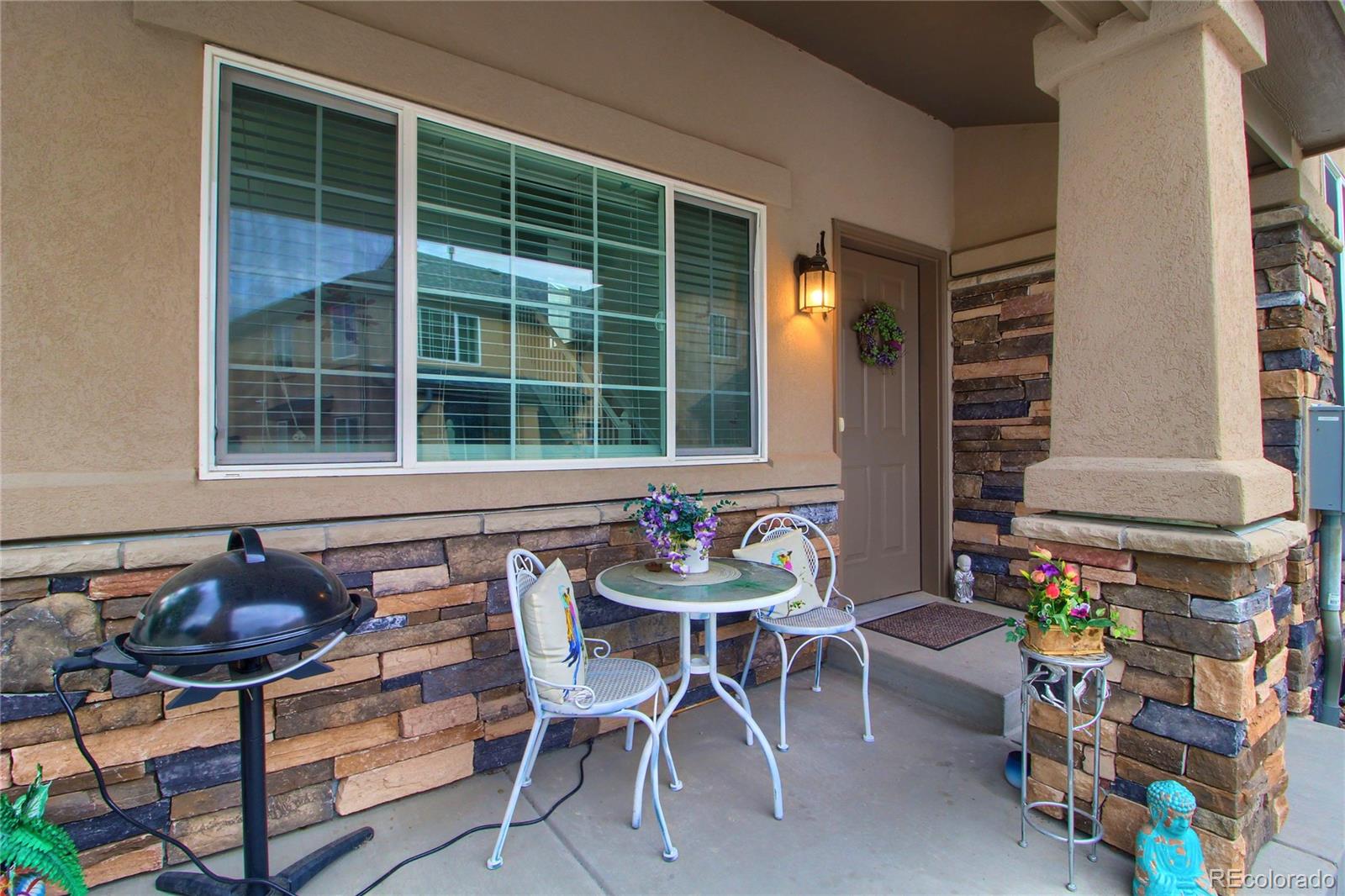 1335 South Chambers Road, Unit 101 Aurora, CO 80017 - Photo 2 of 40 a table and chairs in front of a house