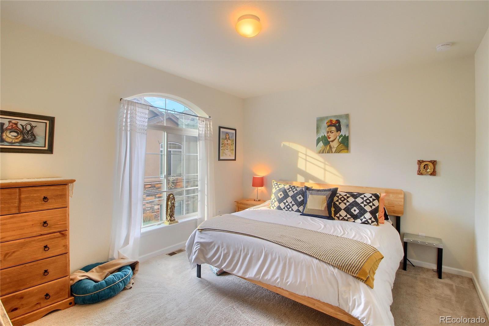 1335 South Chambers Road, Unit 101 Aurora, CO 80017 - Photo 21 of 40 a bedroom with a bed and a window