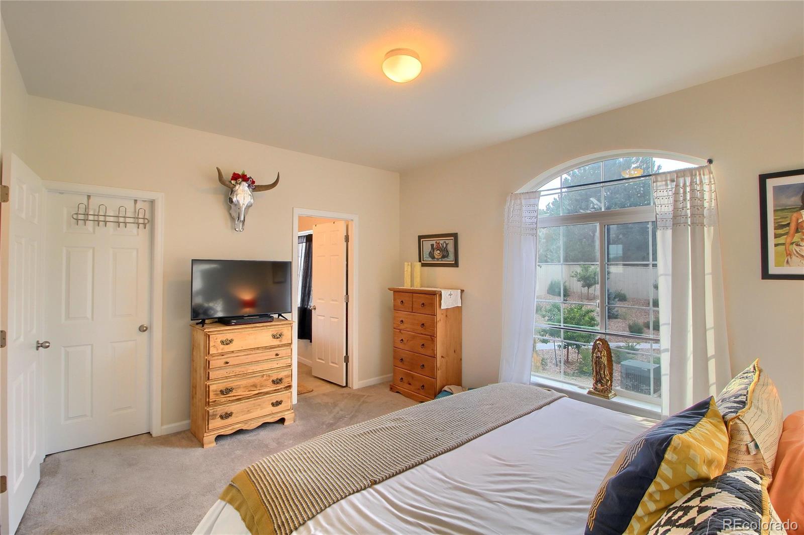 1335 South Chambers Road, Unit 101 Aurora, CO 80017 - Photo 22 of 40 a bedroom with a bed and furniture