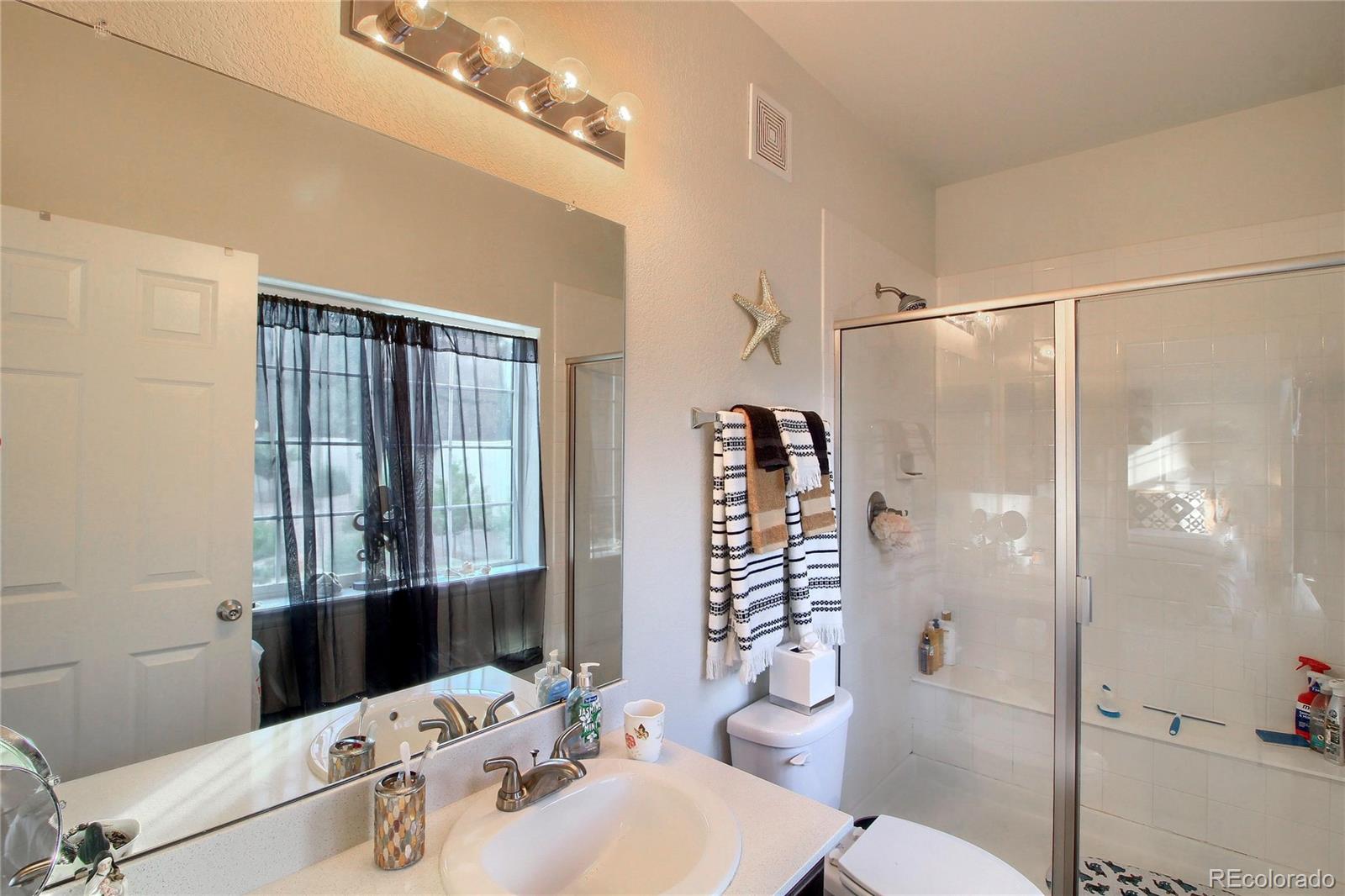 1335 South Chambers Road, Unit 101 Aurora, CO 80017 - Photo 25 of 40 a bathroom with a sink toilet and shower
