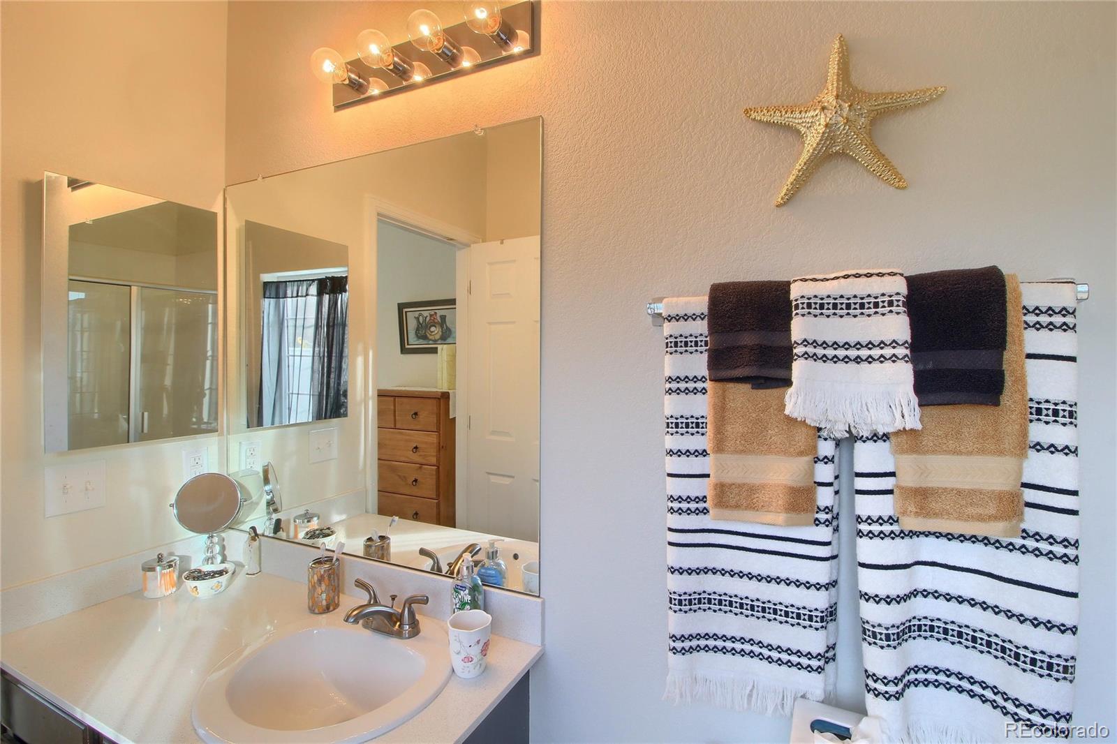 1335 South Chambers Road, Unit 101 Aurora, CO 80017 - Photo 26 of 40 a bathroom with a sink and a mirror